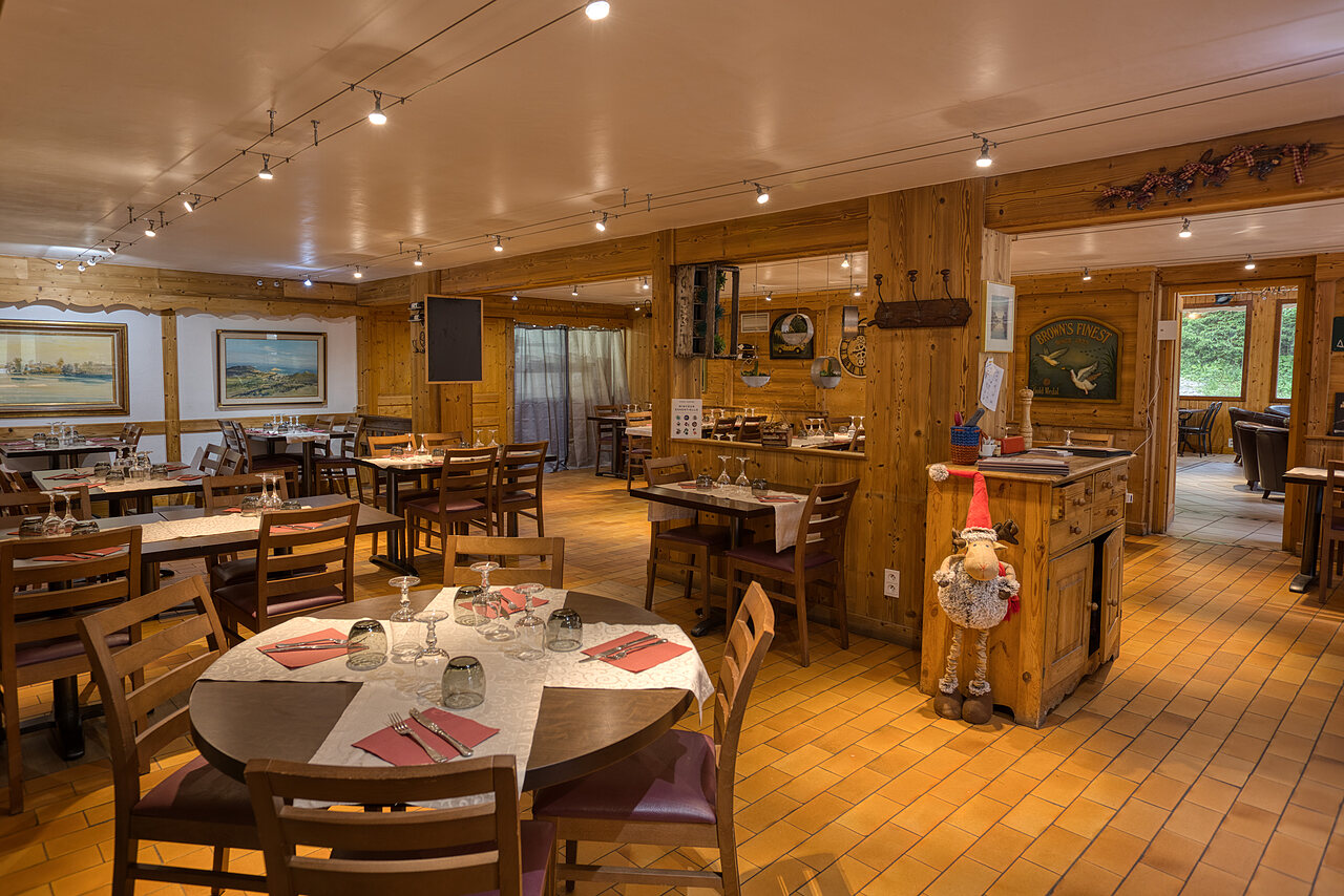 Gezellige restaurantzaal met gedekte tafels op camping CLICOCHIC Alpes Lodges in Pralognan la Vanoise (73).