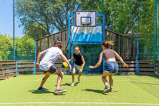 Jongeren basketballen op het multisportterrein van camping CLICOCHIC Baie de Cavalaire.