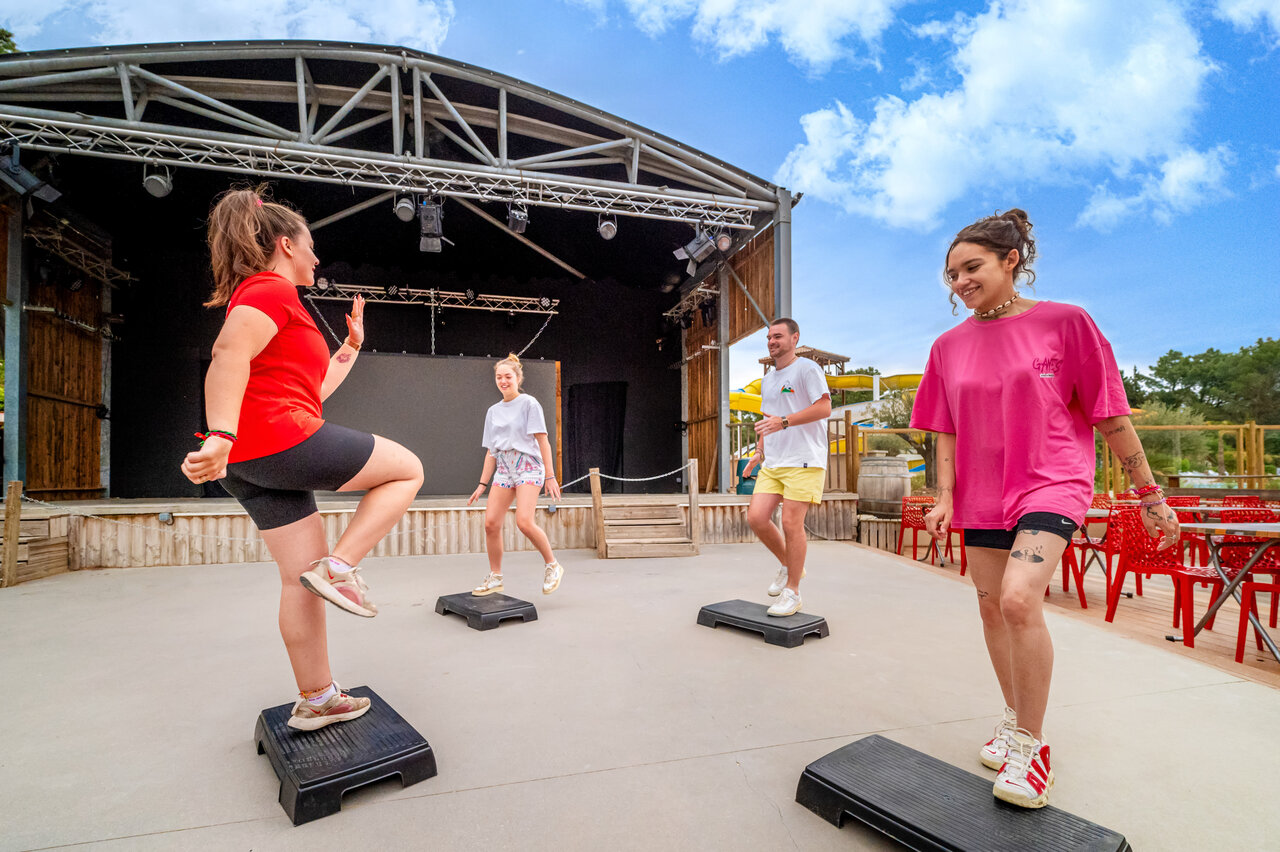 Step aerobics les op buitenpodium bij camping CAPFUN Beauregard in MORNAS (84).