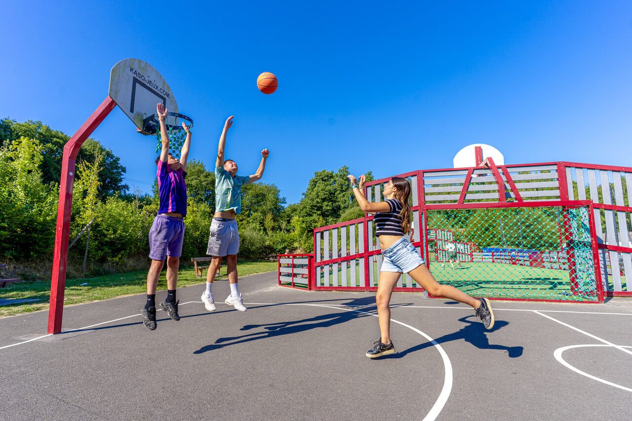 Jongeren basketballen op multisportterrein bij camping CAPFUN Breteche Les Epesses (85).