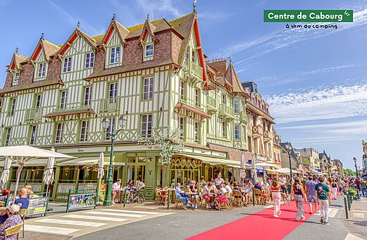 Levendig stadscentrum van Cabourg met typische gebouwen en caf�terrassen.
