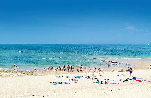 Fijn zandstrand met zwemmers en families op camping CLICOCHIC Cabanes d Oléron in ST GEORGES D'OLERON (17).