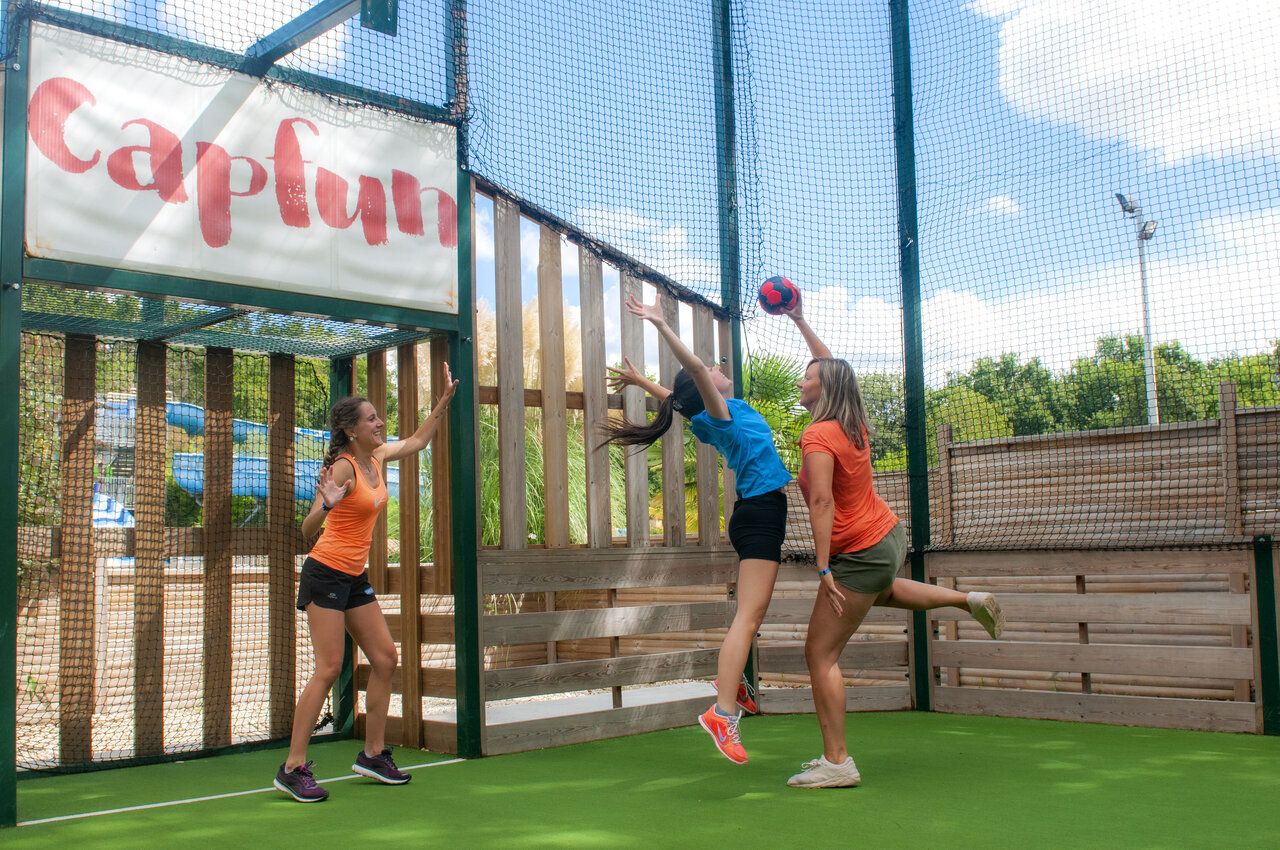 Vrouwen spelen balspel op multisportterrein op camping CAPFUN Ch�nes in Medis/Royan.