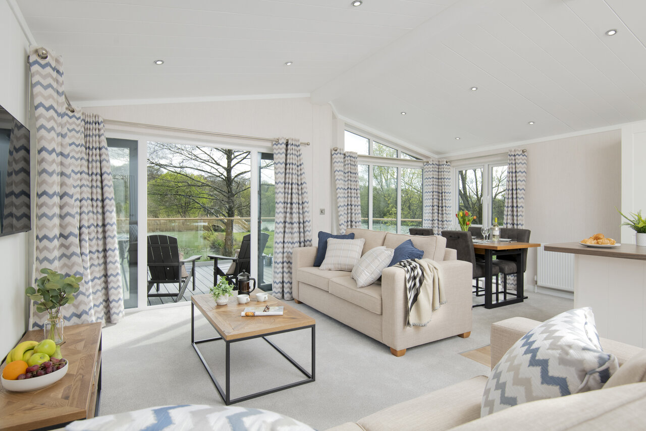 Woonkamer, eetkamer, uitzicht meer, stacaravan CAPFUN UK Clawford Lakes.