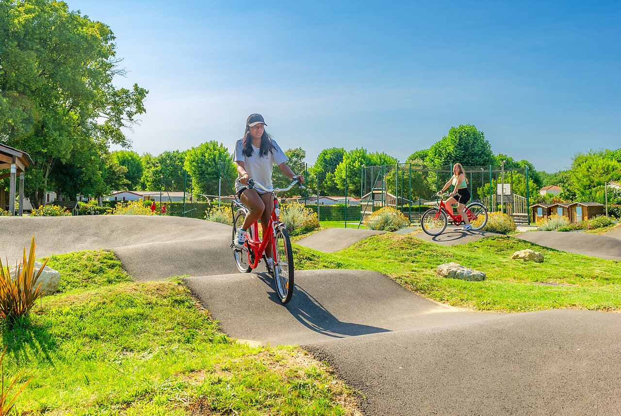 Pumptrack met fietsende vrouwen op camping CAPFUN Coquelicots in Royan (17).
