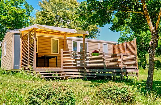Moderne stacaravan met schaduwrijk terras op camping CLICOCHIC Couriou in Recoubeau-Jansac.