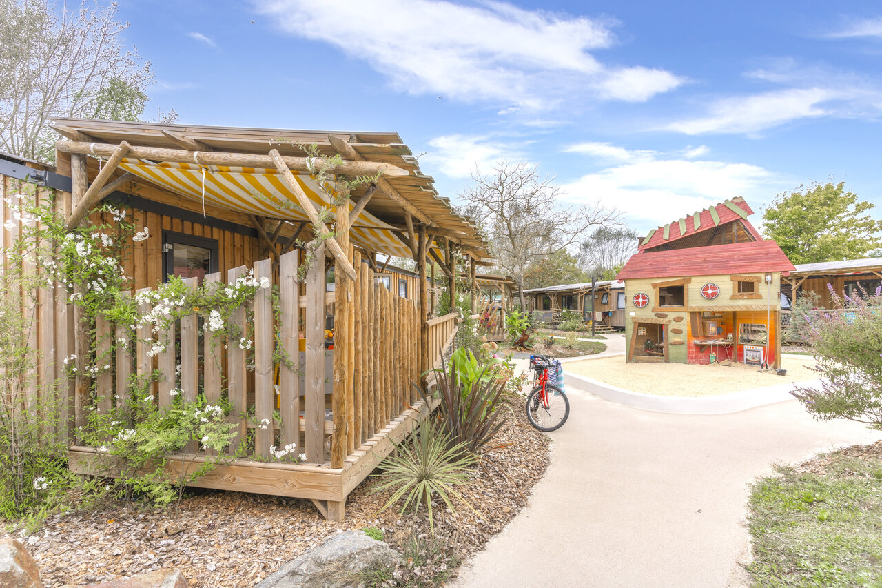 Houten accommodaties, terras en speelhuis bij CAPFUN Dauphins Bleus GIVRAND.