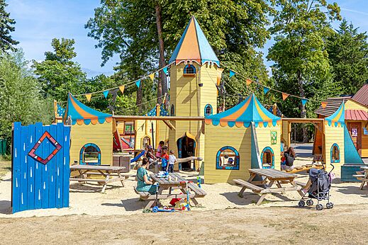 Kleurrijke kasteel speeltuin met kinderen op CAPFUN Dune Fleurie, Quend Plage.