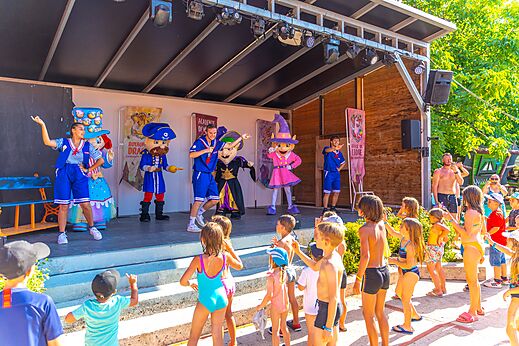 Animatieshow met mascottes en kinderen op het podium op camping CAPFUN Duravel in Duravel (46).