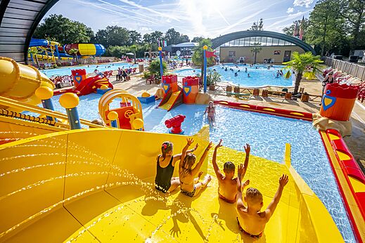 Kinderen op reuzenglijbaan en waterspellen op camping CAPFUN Eibernest in Eibergen.