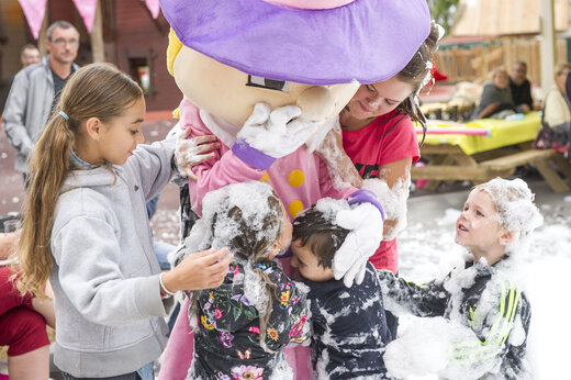 Kinderen spelen met mascotte en schuim tijdens animatie op camping CAPFUN Féerix in MARSEILLAN PLAGE (34).