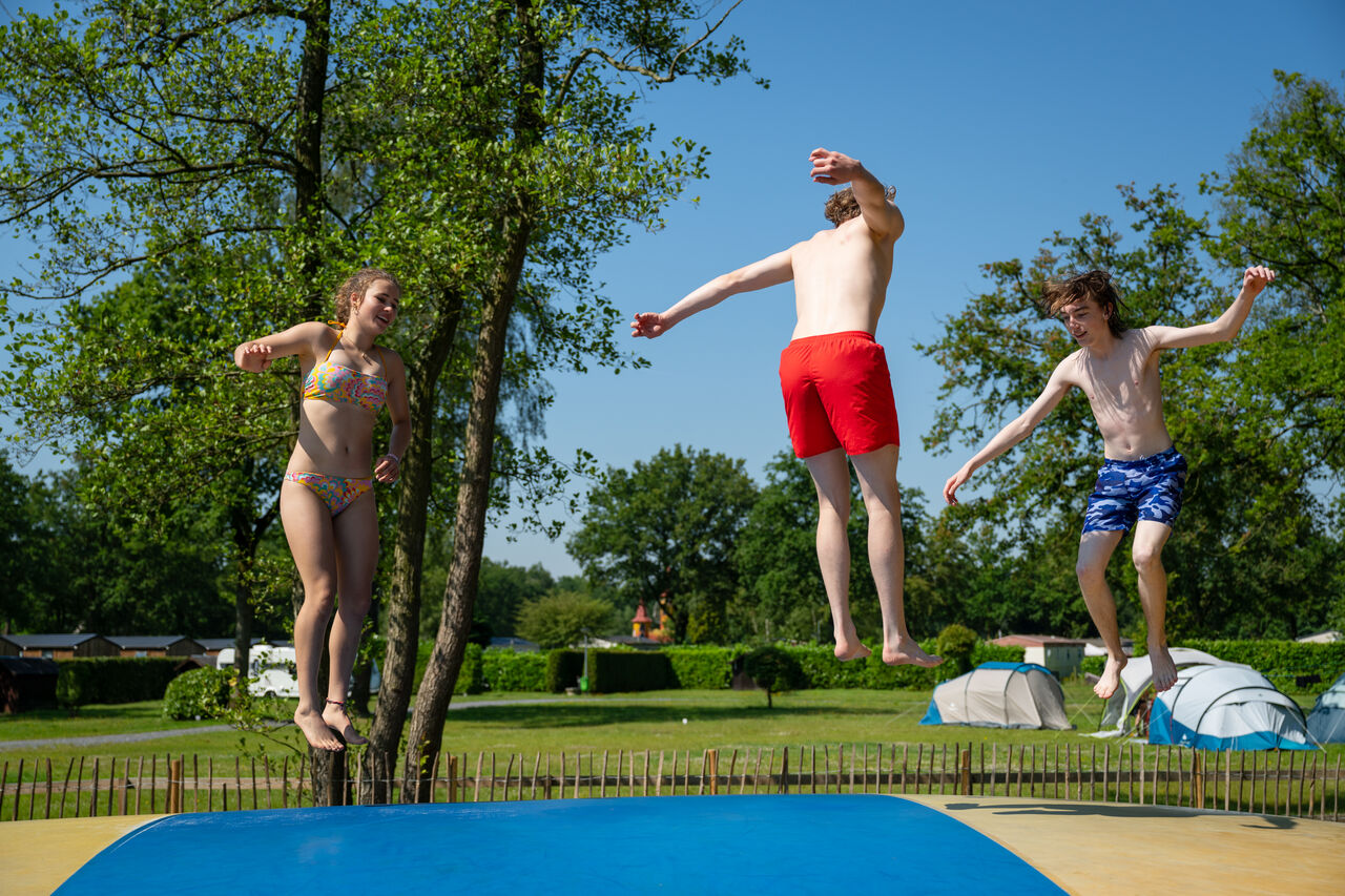 Tieners springen op het springkussen van camping CAPFUN Fort Bedmar in Sint-Gillis-Waas.