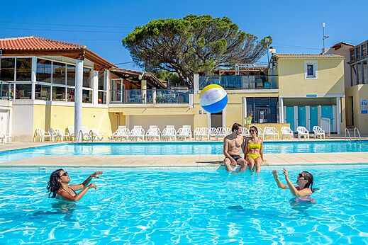 Buitenzwembad met zwemmers en bal op camping CAPFUN Le Fréjus in Fréjus.