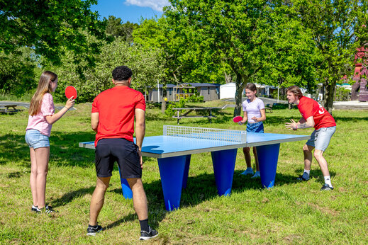 Buiten pingpongtafel en jongeren spelend op camping CAPFUN Grand Large in FOUESNANT (29).