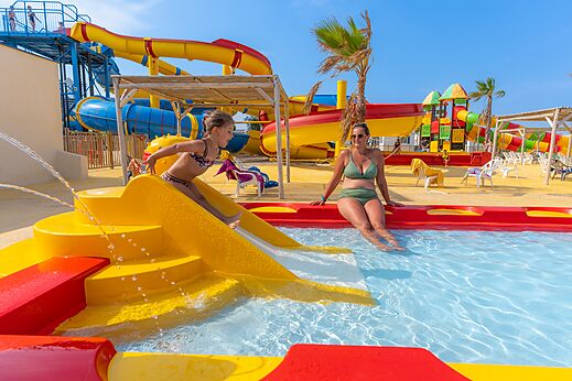 Kleurrijke waterglijbanen en kinderzwembad op camping VAGUES OCEANES Hamacs.