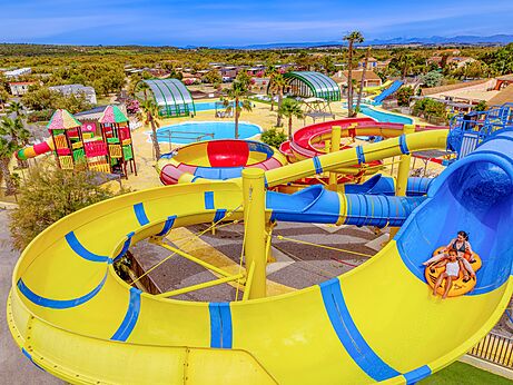Kleurrijke waterglijbanen en buitenzwembad op camping VAGUES OCEANES Hamacs in Fleury (11).
