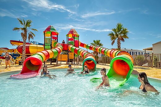 Kleurrijke waterglijbanen en speelzwembad op camping VAGUES OCEANES Hamacs in Fleury (11).
