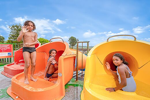 Kinderen vermaken zich op de waterglijbanen op camping CLICOCHIC Haras de Deauville in Touques (14).