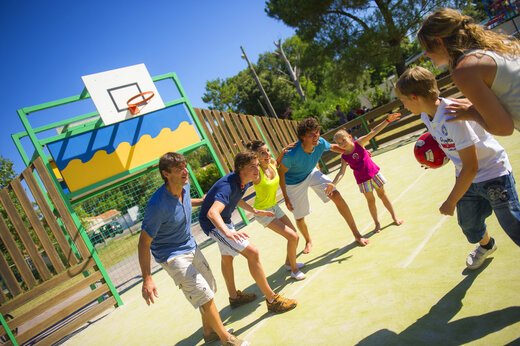 Multisportterrein met familie die basketbal speelt op camping CAPFUN Hauts de Ratebout in STE FOY DE BELVES (24).