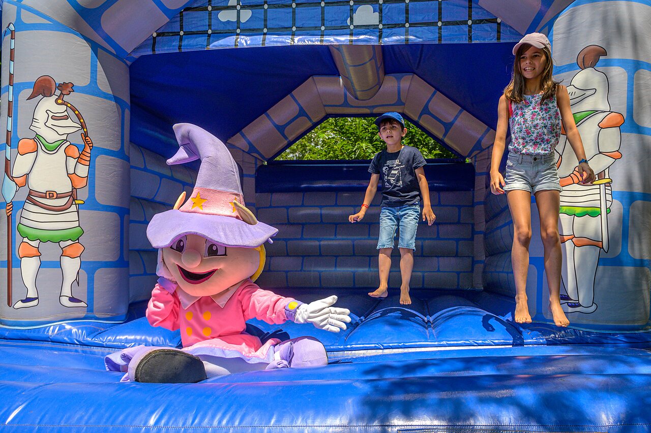 Springkasteel met kinderen en mascotte op camping CAPFUN Hermitage in SERIGNAN (34).