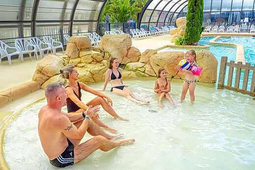 Familie in overdekt zwembad op camping VAGUES OCEANES Les Iles in Hudimesnil (50).