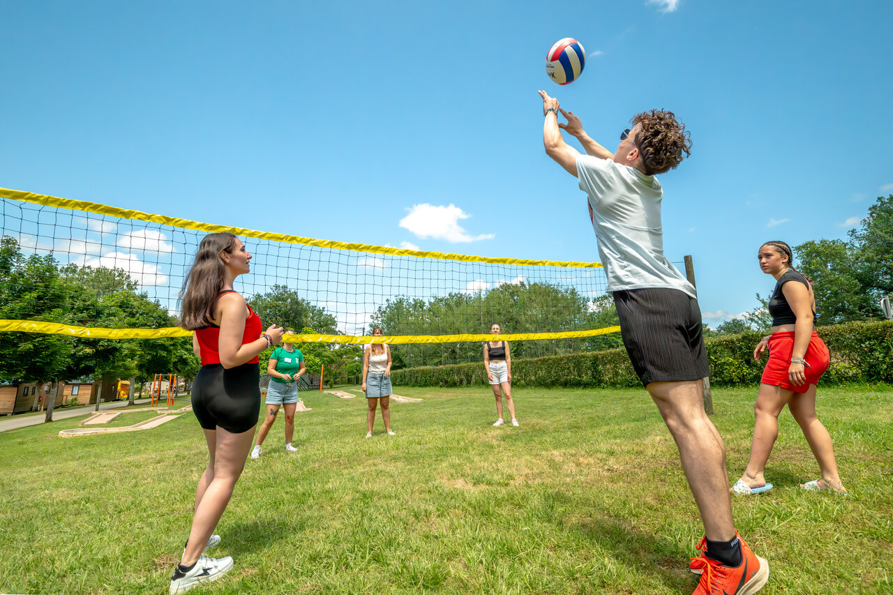 Levendig volleybalspel op sportterrein op camping CLICOCHIC Linotte in Le Bugue.