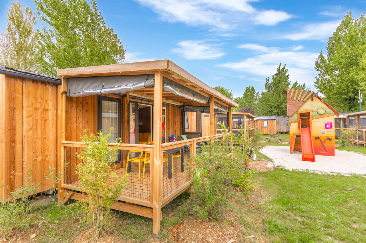 Houten accommodaties met terras en speeltuin op camping CAPFUN Loubine in Les Sables d'Olonne (85).