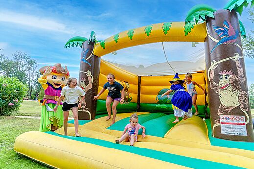 Groot opblaasbaar speeltoestel met kinderen en mascotte op camping CAPFUN Mael in ARGELES SUR MER (66).