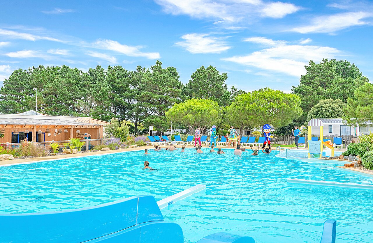 Geanimeerd buitenzwembad met glijbaan en waterspelen op camping VAGUES OCEANES Micheli�re in Givrand (85).