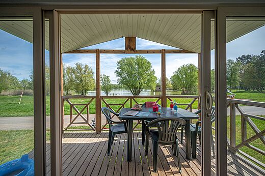 Overdekt terras van stacaravan met uitzicht op meer op camping CAPFUN Mirabelle in VOLSTROFF (57).