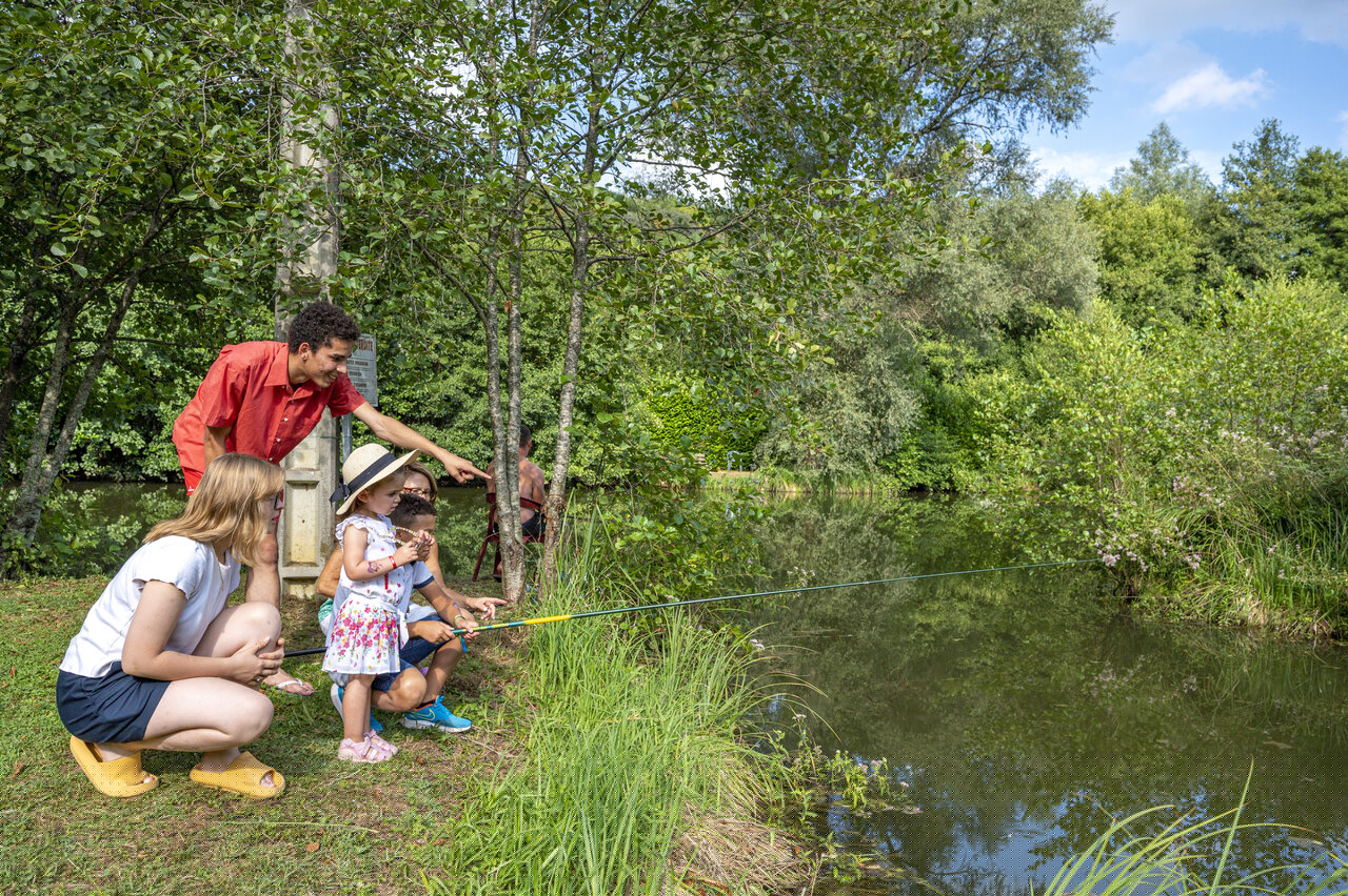 Familie visactiviteit aan de vijver, camping CLICOCHIC Moulin du Roch.