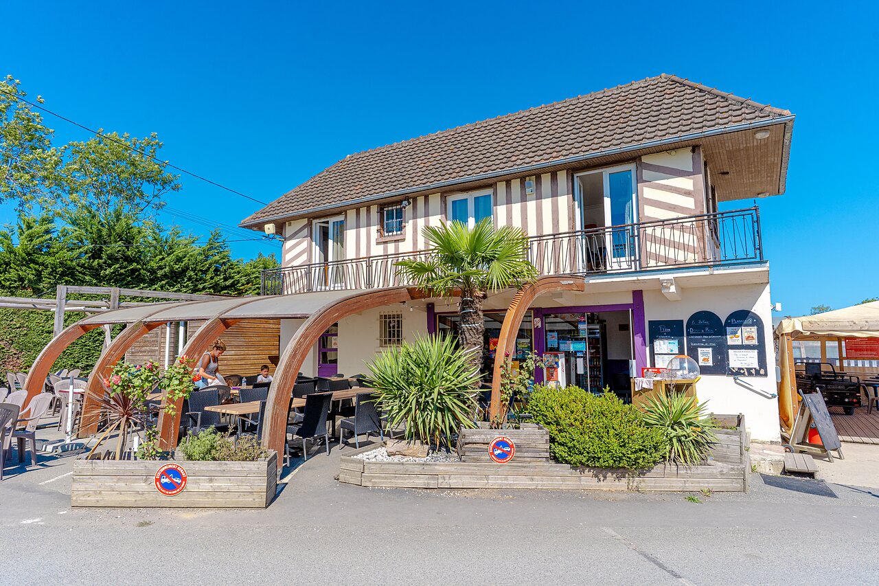 Restaurant en overdekt buitenterras met tafels op camping VAGUES OCEANES Odyss�e in Villers sur mer (14).