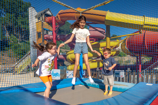 Kinderen op trampoline, waterglijbanen op camping CAPFUN Pachacaid in La Mole (83).