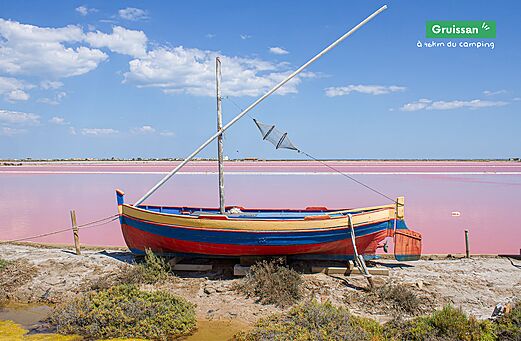 Kleurrijke traditionele boot en roze zoutpannen van Gruissan, bezienswaardigheid nabij de camping.