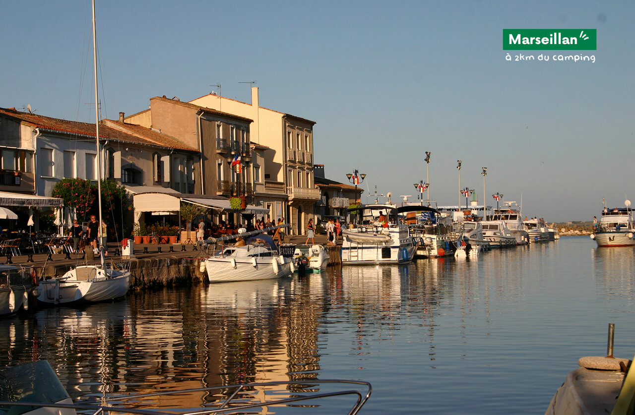 Haven van Marseillan met boten en levendige terrassen, te bezoeken nabij de camping.