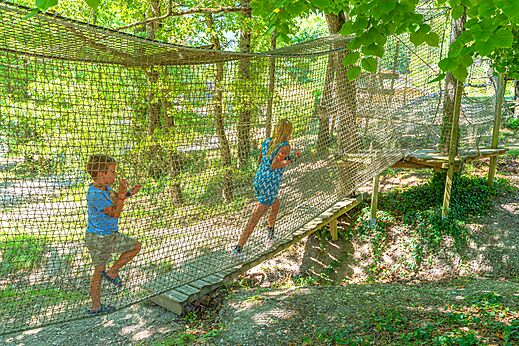Kinderen op net avonturenparcours op camping CLICOCHIC Source du Jabron in Comps (26).