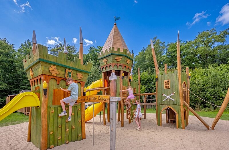 Carabouille Speeltuin - Houten kasteel speeltuin met glijbanen en kinderen op camping CAPFUN het Winkel in Winterswijk.
