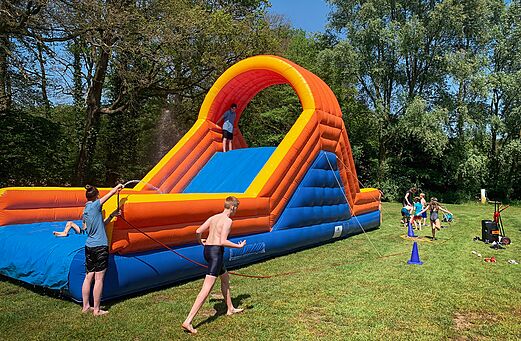 Grote opblaasbare waterglijbaan voor kinderen op camping CAPFUN het Winkel in Winterswijk.