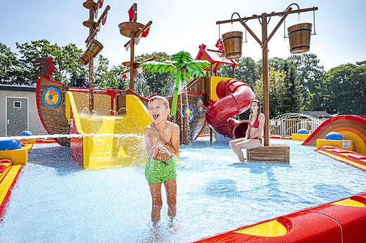 Waterspeeltuin met glijbaan en piratenschip op camping CAPFUN Zeumersehof in Voorthuizen.